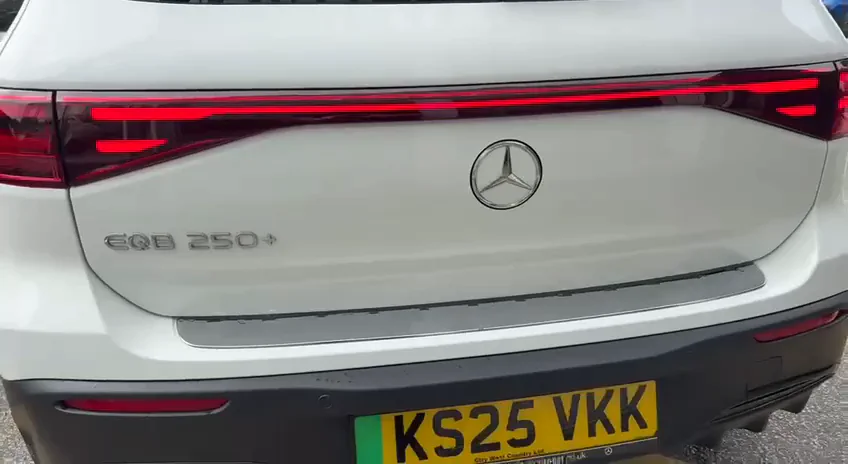 Rear view of the white Mercedes-Benz EQB, showing its EQB 250+ badge at the UK dealership